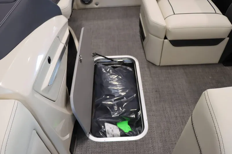 Slide: The Image of 2025 Barletta Lusso 23U boat interior with open storage compartment and seating. - 16