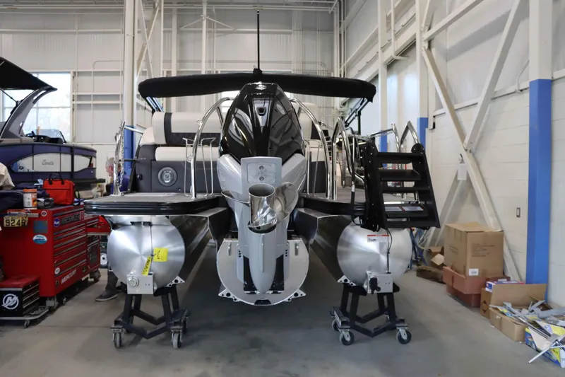 Slide: The Image of 2025 Barletta Lusso 23U pontoon boat in a workshop setting. - 2