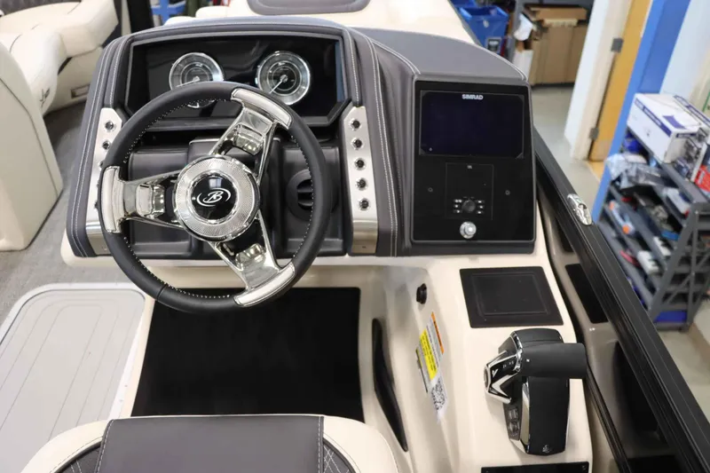 Slide: The Image of 2025 Barletta Lusso 23U boat dashboard with steering wheel and control panel. - 7