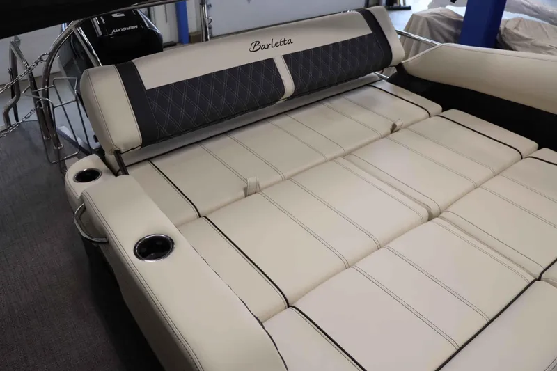Slide: The Image of 2025 Barletta Lusso 23U boat interior with luxurious beige seating and cup holders. - 8