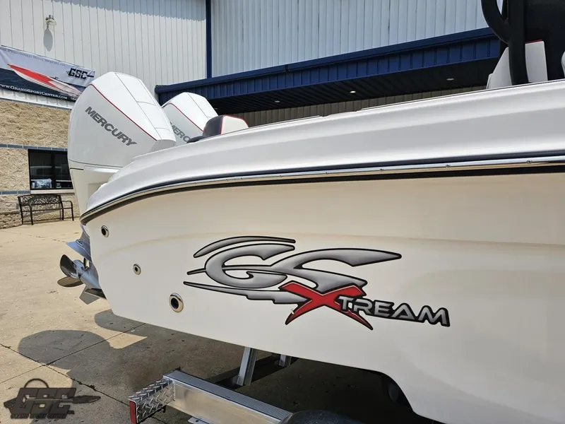 Slide: The Image of 2024 Glasstream 280 Pro GSX boat with Mercury engines, docked outside a building. - 10