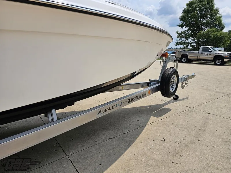 Slide: The Image of 2024 Glasstream 280 Pro GSX boat on a Magic Tilt trailer in a parking lot. - 20