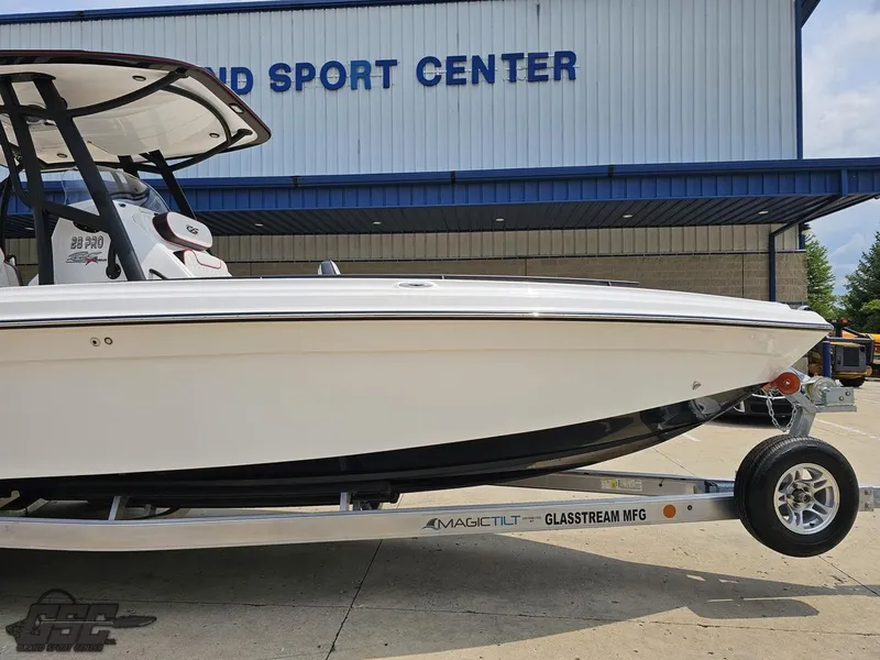 Slide: The Image of 2024 Glasstream 280 Pro GSX boat on a trailer outside a sport center. - 5