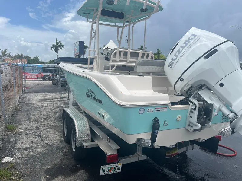 Slide: The Image of 2025 Sea Chaser 22 HFC boat with Suzuki outboard motor on trailer. - 12