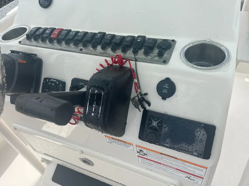 Slide: The Image of Control panel of 2025 Sea Chaser 22 HFC boat with throttle and switches. - 14