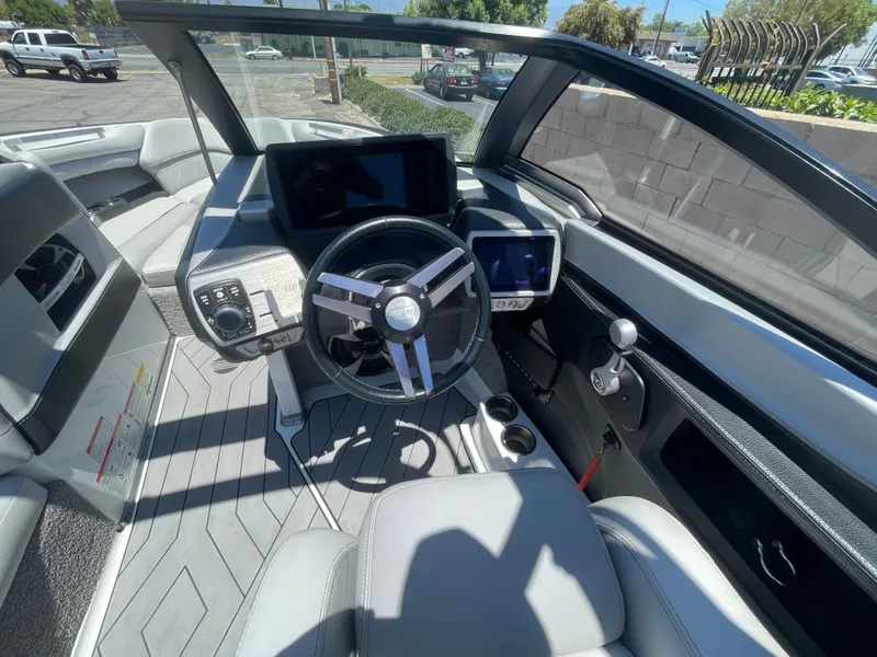 Slide: The Image of 2017 Malibu Wakesetter 25 LSV boat cockpit with modern steering and control panels. - 11