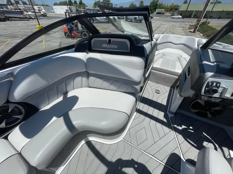 Slide: The Image of 2017 Malibu Wakesetter 25 LSV interior with gray and white seating. - 12