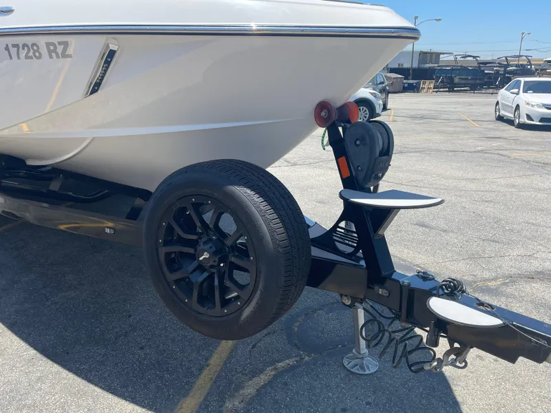 Slide: The Image of 2017 Malibu Wakesetter 25 LSV boat on a trailer in a parking lot. - 5