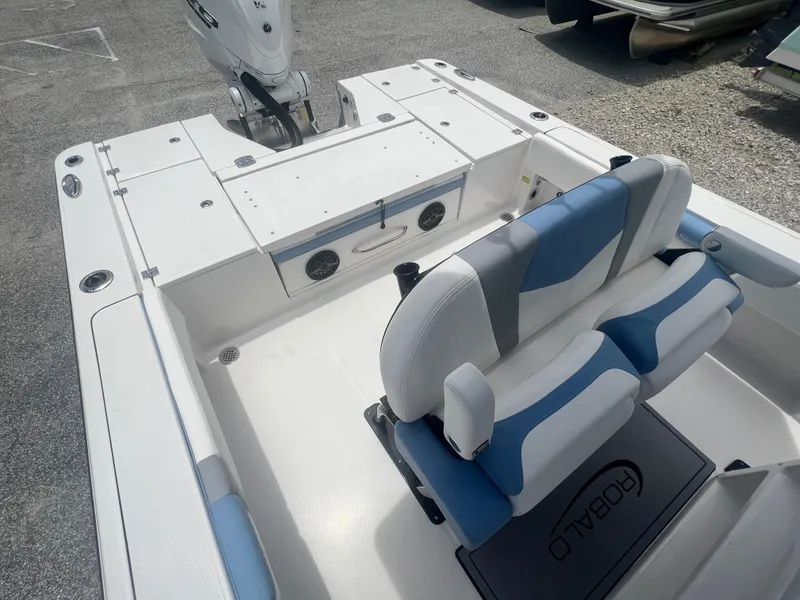 Slide: The Image of 2025 Robalo 266 Cayman SD boat interior with seating and storage compartments. - 11