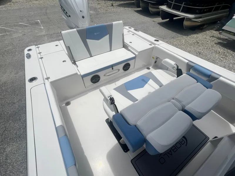 Slide: The Image of 2025 Robalo 266 Cayman SD boat interior with white and blue seating. - 12