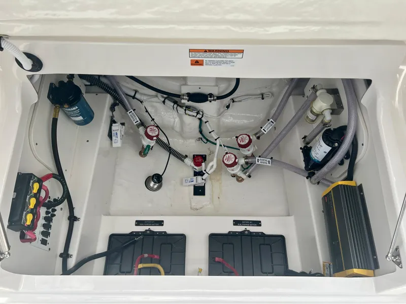 Slide: The Image of 2025 Robalo 266 Cayman SD engine compartment with wiring and components. - 13