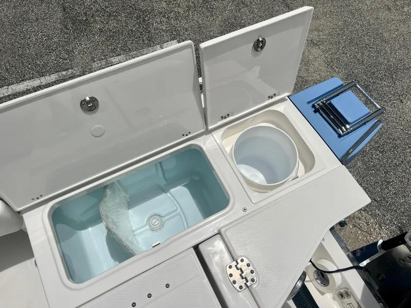 Slide: The Image of 2025 Robalo 266 Cayman SD boat storage compartments and ladder. - 14