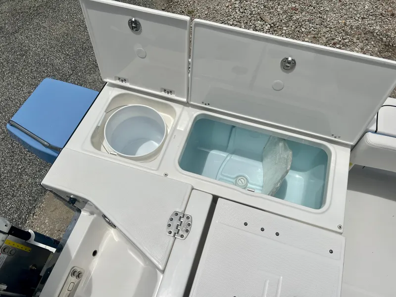 Slide: The Image of 2025 Robalo 266 Cayman SD boat storage compartments and livewell. - 15