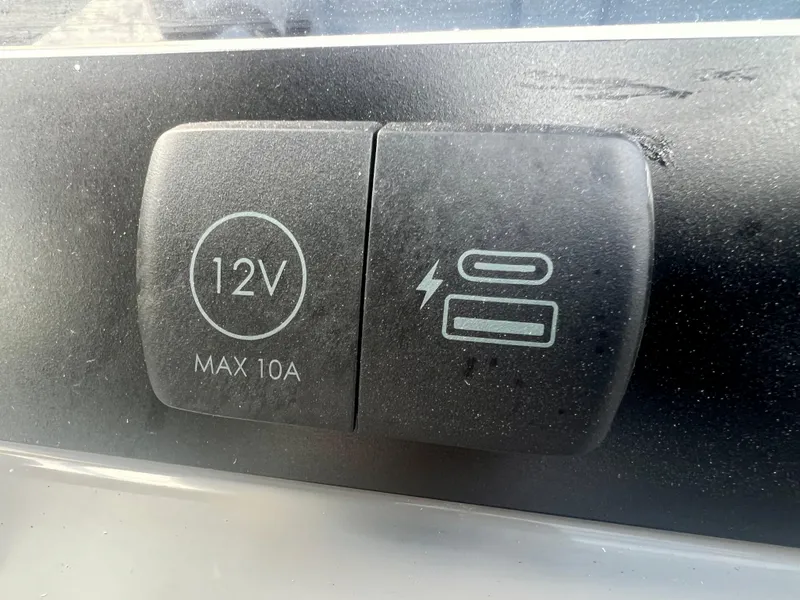 Slide: The Image of 12V power outlet and USB charging ports on 2025 Robalo 266 Cayman SD boat. - 20