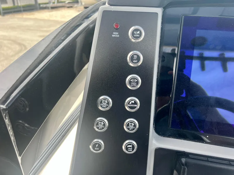 Slide: The Image of Control panel of the 2025 Robalo 266 Cayman SD boat with various function buttons. - 23