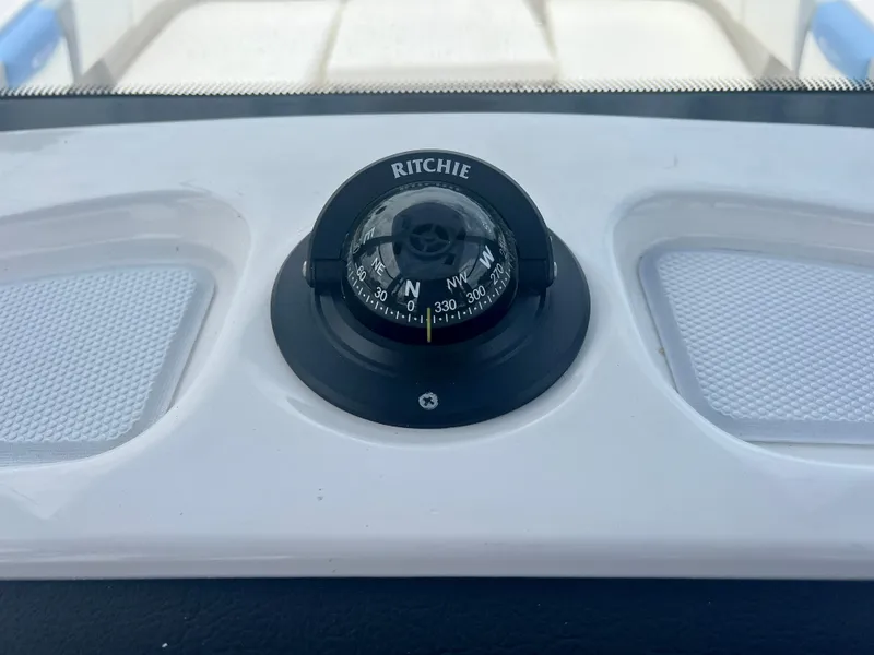 Slide: The Image of Compass on the dashboard of a 2025 Robalo 266 Cayman SD boat. - 26