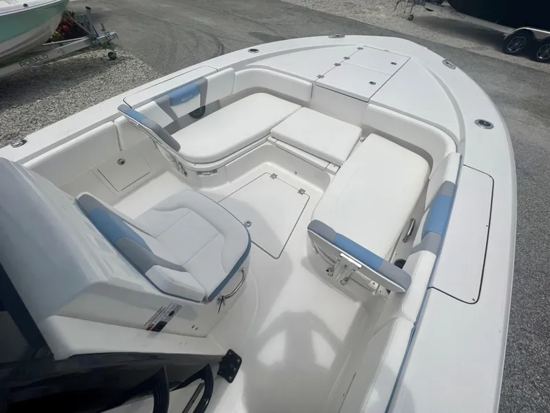 Slide: The Image of 2025 Robalo 266 Cayman SD boat interior with white and blue seating. - 27