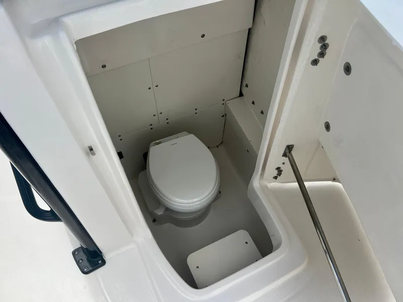 Slide: The Image of 2025 Robalo 266 Cayman SD boat interior with built-in toilet. - 29