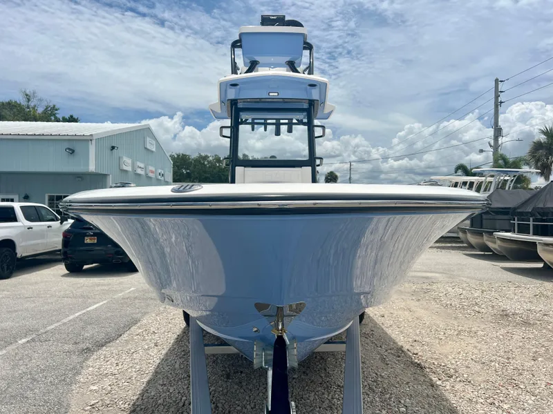 Slide: The Image of 2025 Robalo 266 Cayman SD boat front view at dealership. - 3
