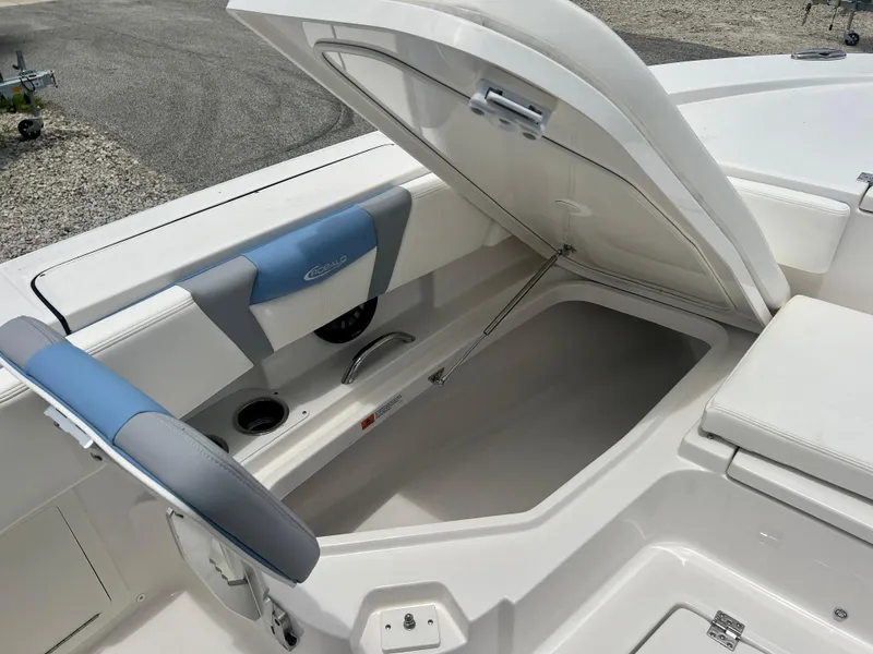 Slide: The Image of 2025 Robalo 266 Cayman SD boat storage compartment with open lid. - 32