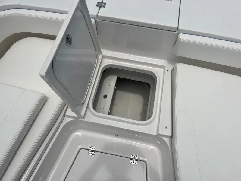 Slide: The Image of Open storage compartment on the 2025 Robalo 266 Cayman SD boat. - 34