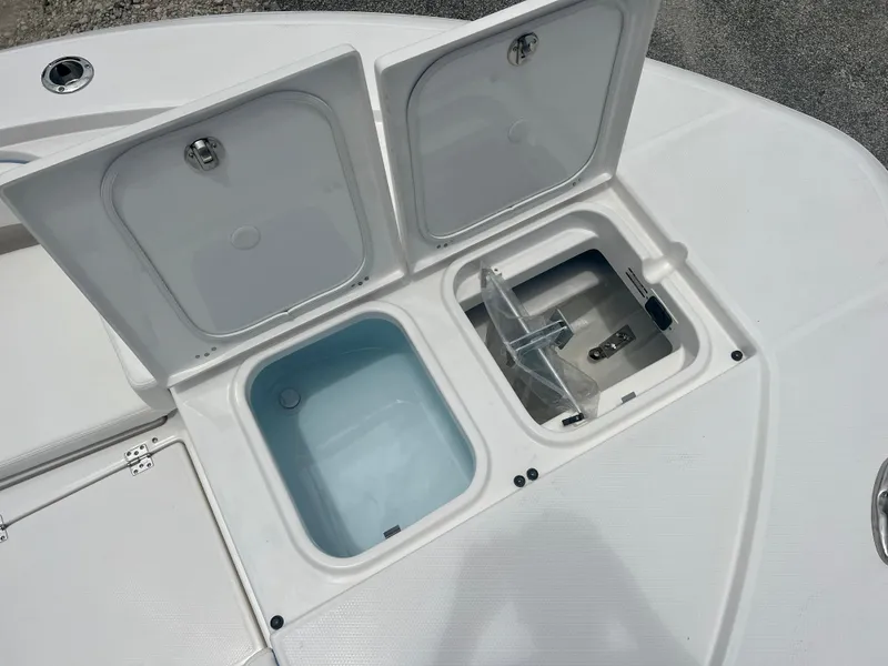 Slide: The Image of 2025 Robalo 266 Cayman SD storage compartments and livewell. - 35