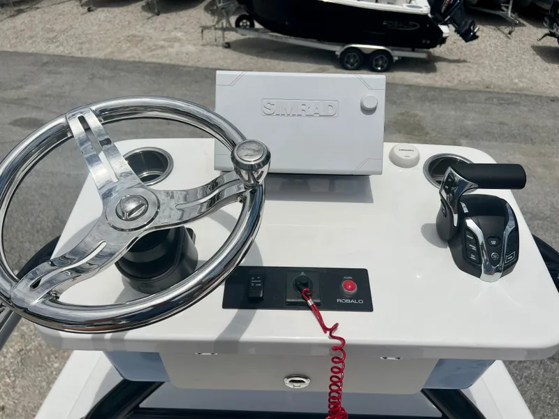 Slide: The Image of Control console of 2025 Robalo 266 Cayman SD boat with steering wheel and throttle. - 36