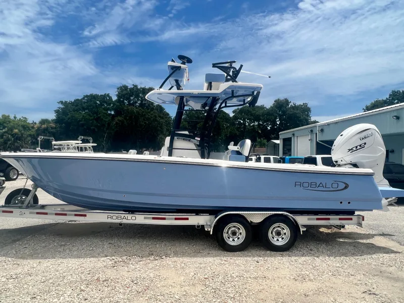 Slide: The Image of 2025 Robalo 266 Cayman SD boat on trailer, side view, blue hull, Yamaha outboard motor. - 5