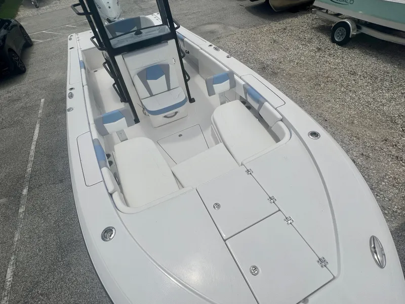 Slide: The Image of 2025 Robalo 266 Cayman SD boat interior with white and blue seating. - 9