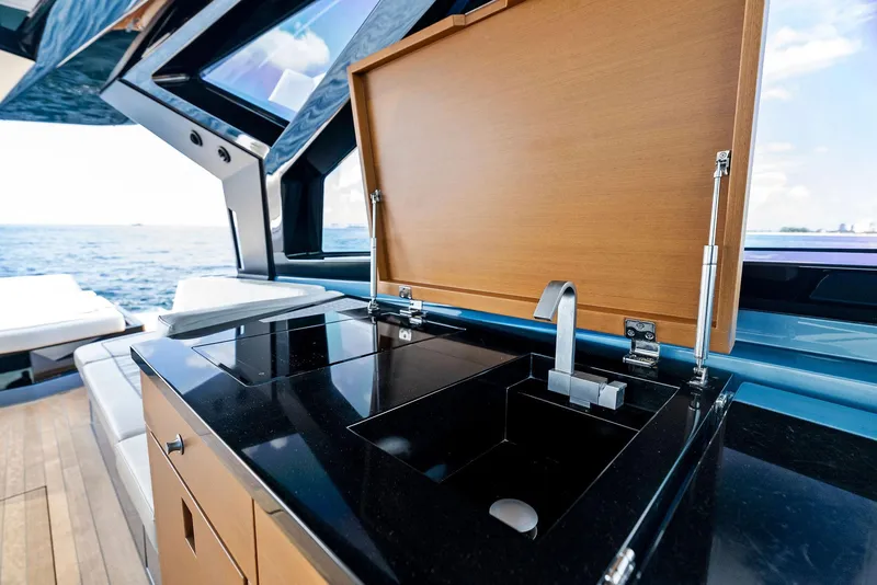 Slide: The Image of Luxurious 2023 Wally WALLYPOWER58 yacht kitchen with sleek black countertop and modern sink. - 19