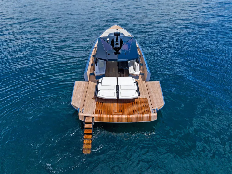 Slide: The Image of 2023 Wally WALLYPOWER58 yacht on open water, featuring sleek design and wooden deck. - 8