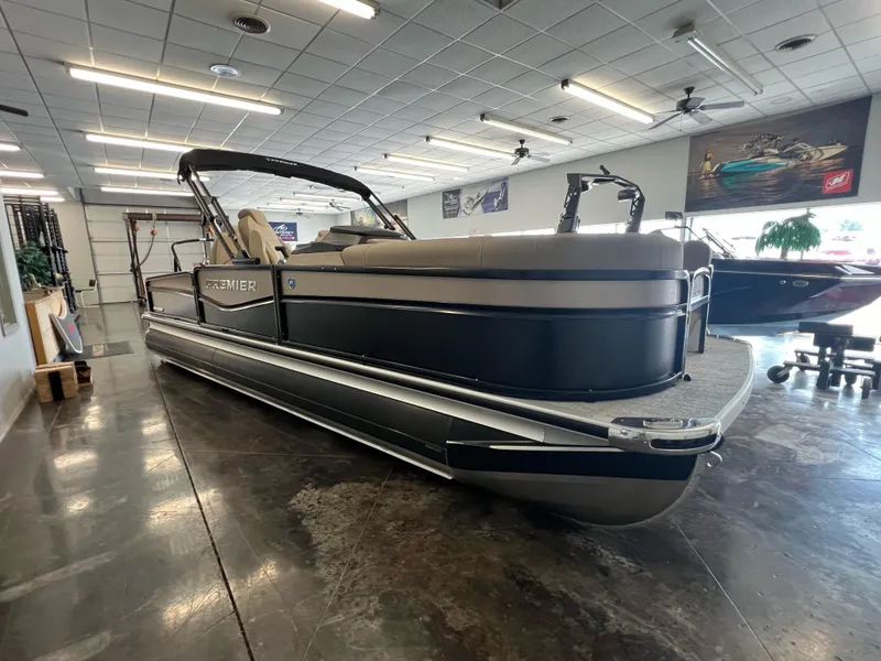 Slide: The Image of 2025 Premier Sunsation 230 Angler pontoon boat in showroom. - 1