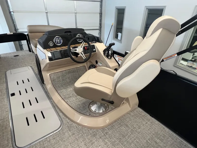 Slide: The Image of 2025 Premier Sunsation 230 Angler boat interior with captain's chair and control console. - 10
