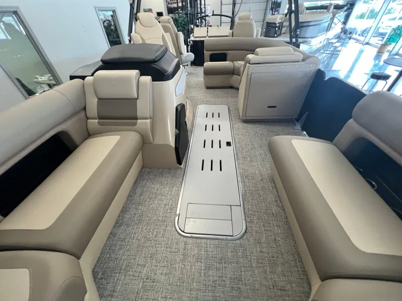 Slide: The Image of 2025 Premier Sunsation 230 Angler interior with beige seating and spacious layout. - 11