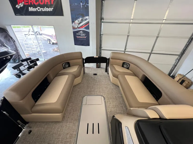 Slide: The Image of 2025 Premier Sunsation 230 Angler boat interior with beige seating in a showroom. - 12