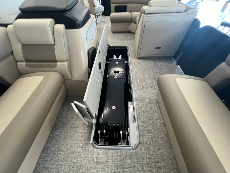 Slide: The Image of Premier Sunsation 230 Angler 2025 interior with open storage compartment. - 17