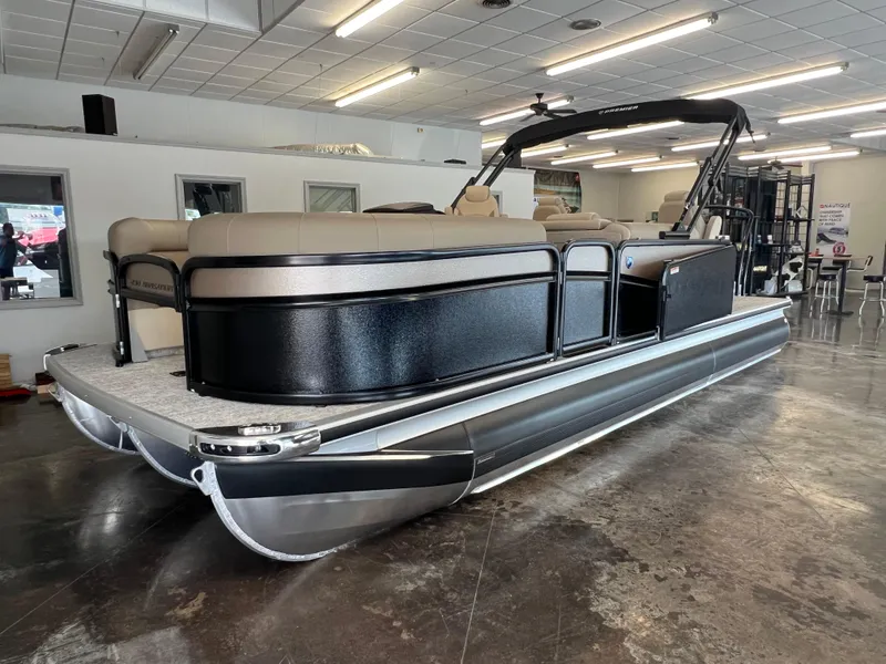 Slide: The Image of 2025 Premier Sunsation 230 Angler pontoon boat in showroom. - 2