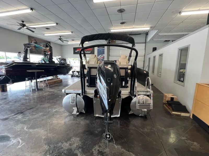 Slide: The Image of 2025 Premier Sunsation 230 Angler pontoon boat displayed in a showroom. - 5