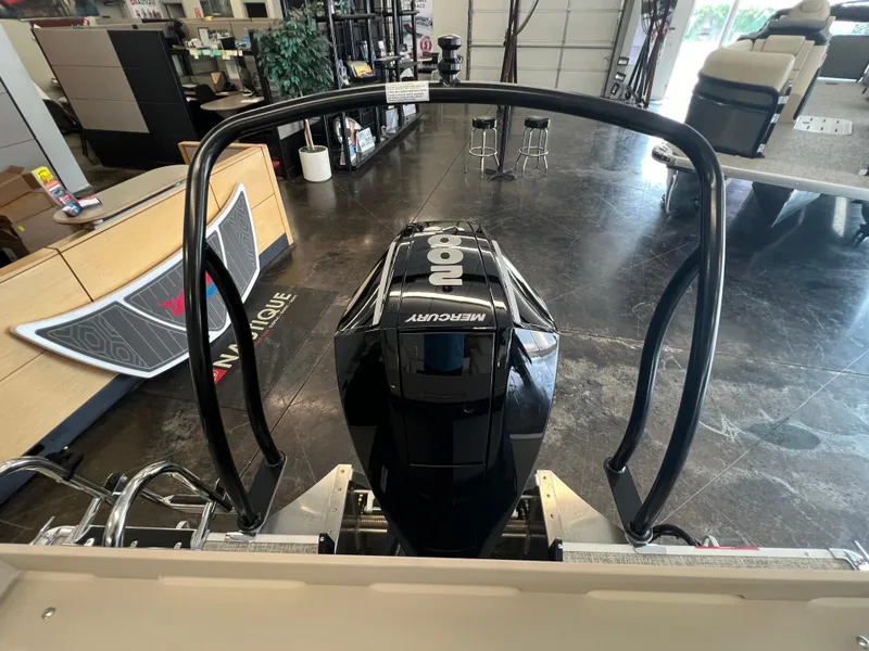Slide: The Image of 2025 Premier Sunsation 230 Angler with Mercury outboard motor in showroom. - 6