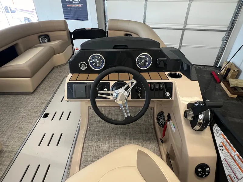 Slide: The Image of 2025 Premier Sunsation 230 Angler boat interior with steering console and seating. - 9