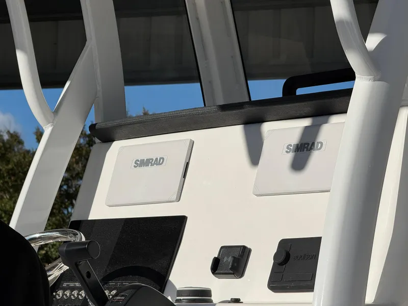Slide: The Image of 2025 Sea Pro 242 Center Console dashboard with Simrad electronics. - 2