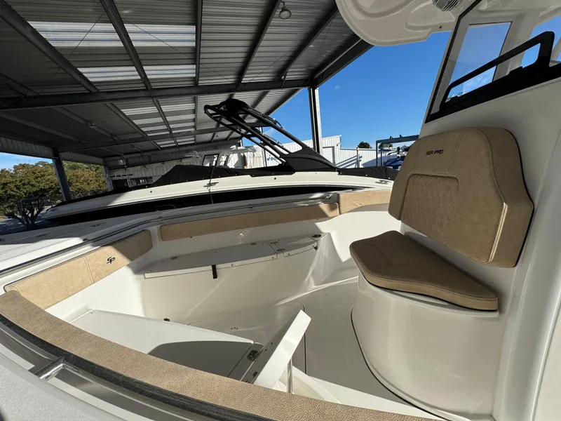 Slide: The Image of 2025 Sea Pro 242 Center Console boat interior under a metal canopy. - 3