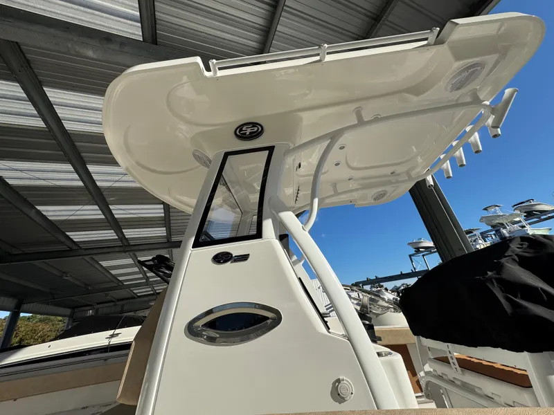 Slide: The Image of 2025 Sea Pro 242 Center Console boat under a metal canopy, showcasing its sleek design. - 4