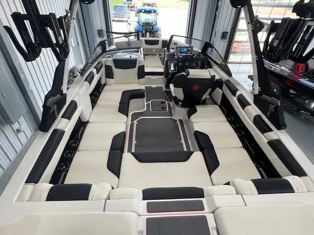 Slide: The Image of 2024 Malibu M220 boat interior with spacious seating and modern dashboard. - 10