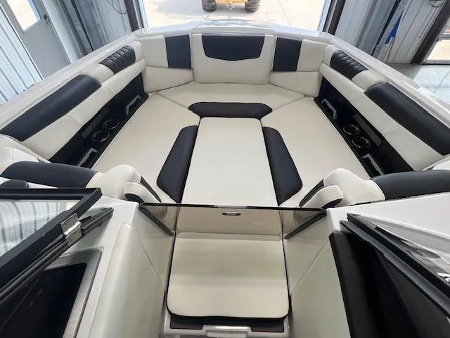 Slide: The Image of 2024 Malibu M220 boat interior with white and black seating. - 13