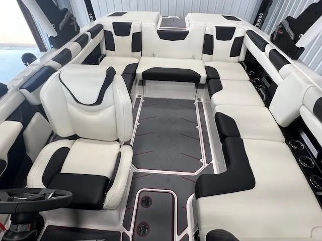 Slide: The Image of 2024 Malibu M220 boat interior with white and black seating. - 14