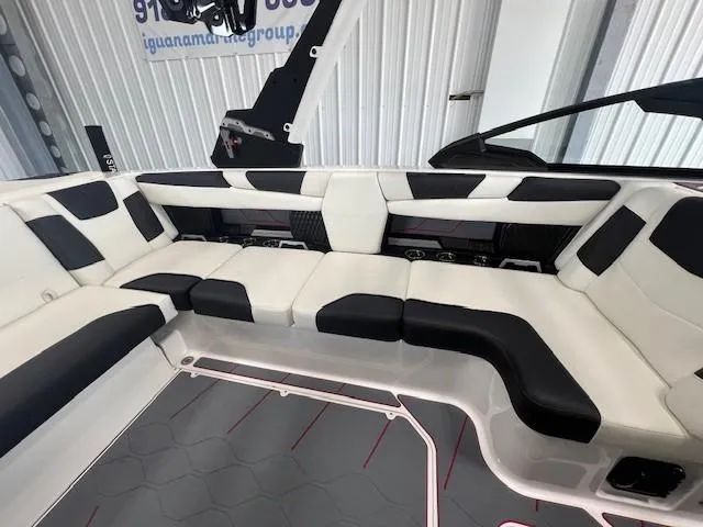 Slide: The Image of 2024 Malibu M220 boat interior with black and white seating. - 16