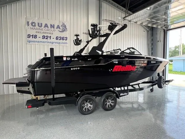 Slide: The Image of 2024 Malibu M220 boat on trailer at Iguana Marine Group showroom. - 5