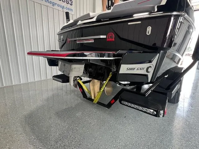 Slide: The Image of 2024 Malibu M220 boat rear view with swim platform and Surf Gate system. - 6