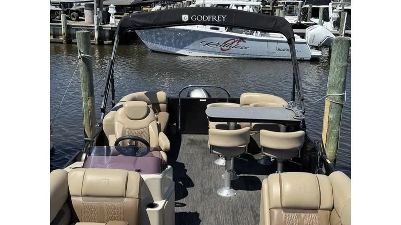 Slide: The Image of 2020 Godfrey SWEETWATER 2286 MT pontoon boat with beige seating, docked at marina. - 6